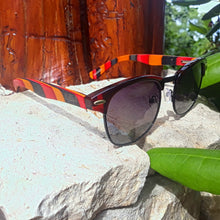 Load image into Gallery viewer, multi colored bamboo sunglasses outdoors