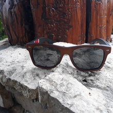 Load image into Gallery viewer, red stripe bamboo sunglasses front view outside
