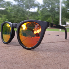 Load image into Gallery viewer, sunset mirror sunglasses with black wood arms outdoors