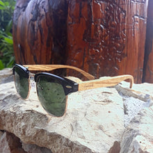 Load image into Gallery viewer, walnut wood sunglasses with green lenses outdoors